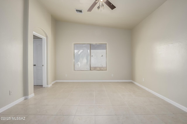 unfurnished room featuring ceiling fan, light tile patterned floors, and lofted ceiling