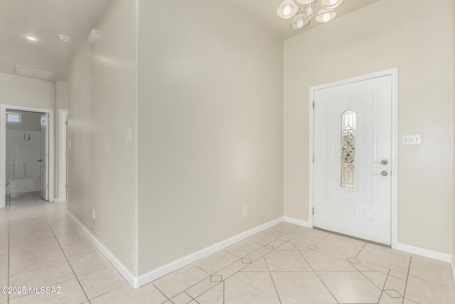 foyer entrance featuring a chandelier and light tile patterned flooring