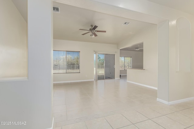 spare room featuring ceiling fan, beamed ceiling, and light tile patterned flooring