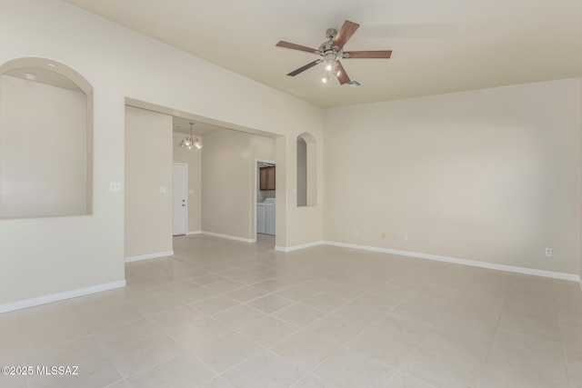 empty room with ceiling fan, washer and clothes dryer, and light tile patterned flooring