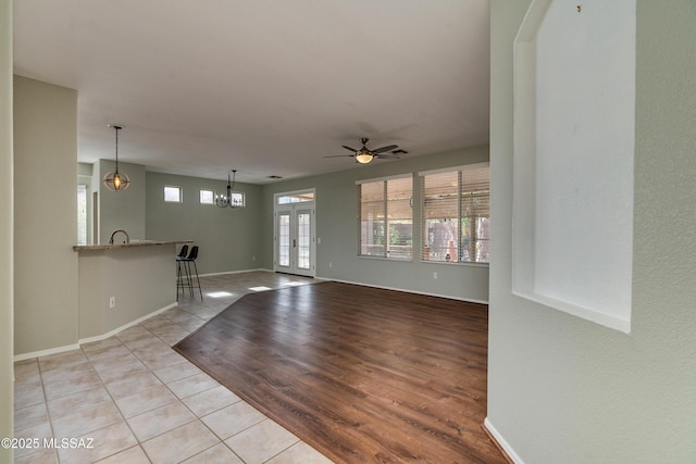 spare room featuring french doors, ceiling fan, and light tile patterned floors