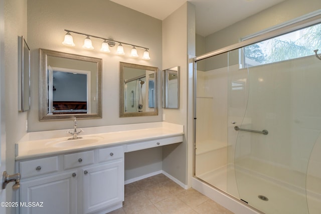 bathroom featuring tile patterned floors, an enclosed shower, and vanity