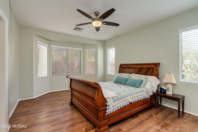 bedroom with dark wood-type flooring and ceiling fan