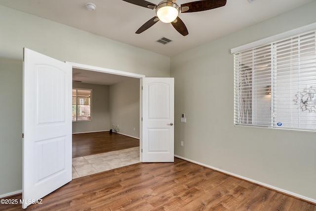 spare room with hardwood / wood-style flooring and ceiling fan