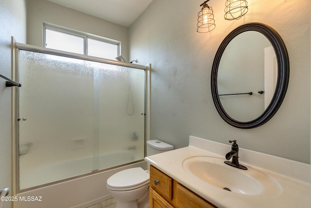 full bathroom featuring vanity, enclosed tub / shower combo, and toilet