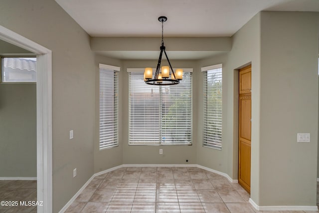 unfurnished dining area featuring light tile patterned floors and a notable chandelier