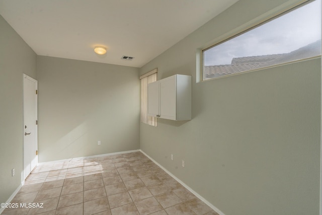 spare room with light tile patterned flooring