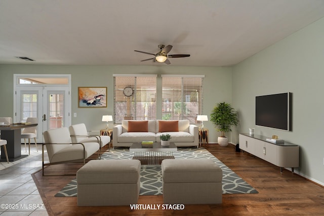 living room with french doors, ceiling fan, and dark hardwood / wood-style flooring