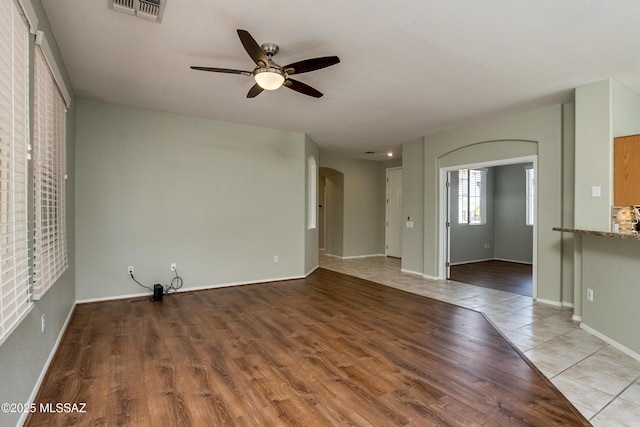 spare room with light hardwood / wood-style flooring and ceiling fan