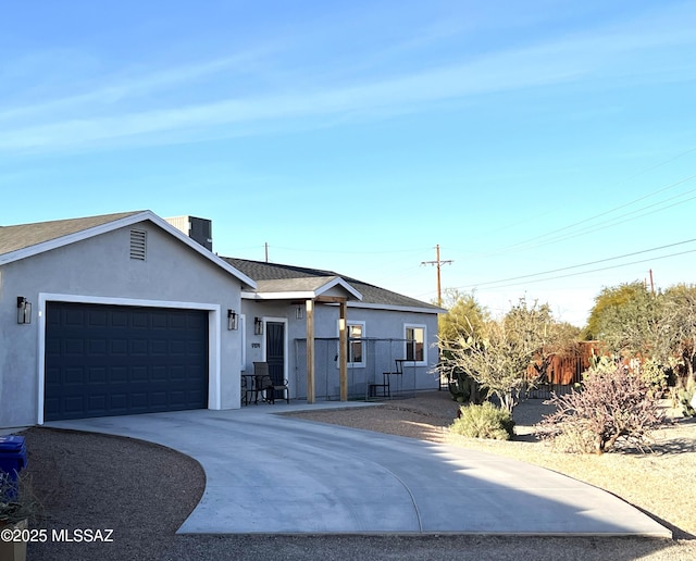 ranch-style house featuring a garage and central AC unit