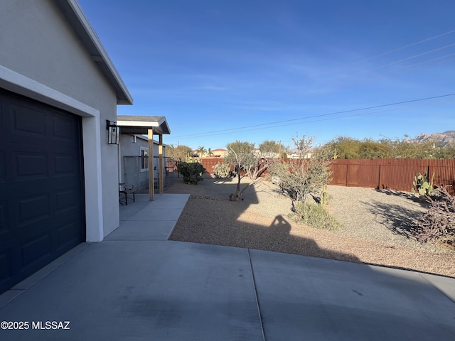 view of yard featuring a patio area and a garage