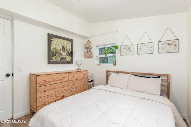 bedroom with hardwood / wood-style flooring