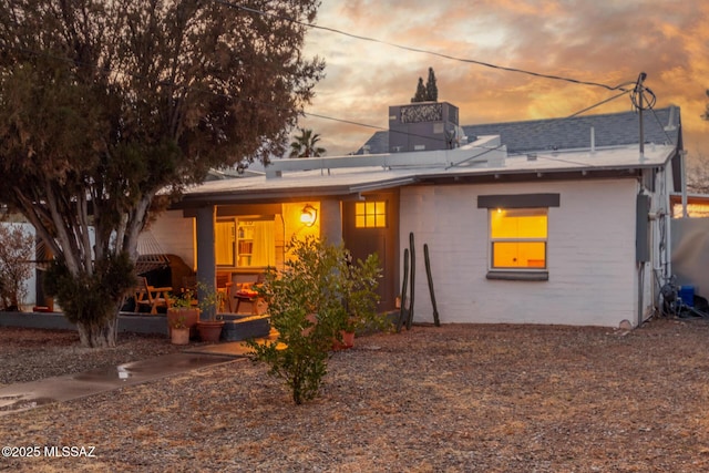 view of back house at dusk