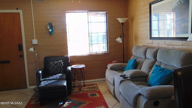 living room featuring brick wall and light tile patterned floors