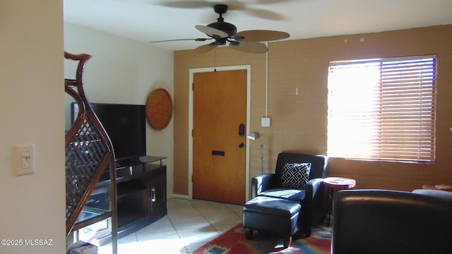 tiled living room with ceiling fan