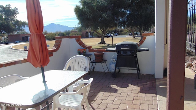 view of patio / terrace featuring a mountain view and a grill