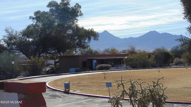 exterior space featuring a mountain view and a yard