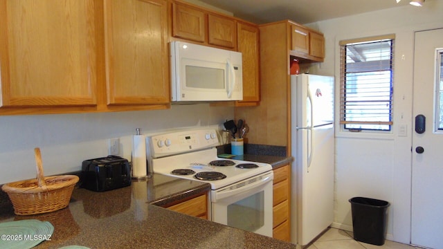 kitchen featuring white appliances and light tile patterned floors