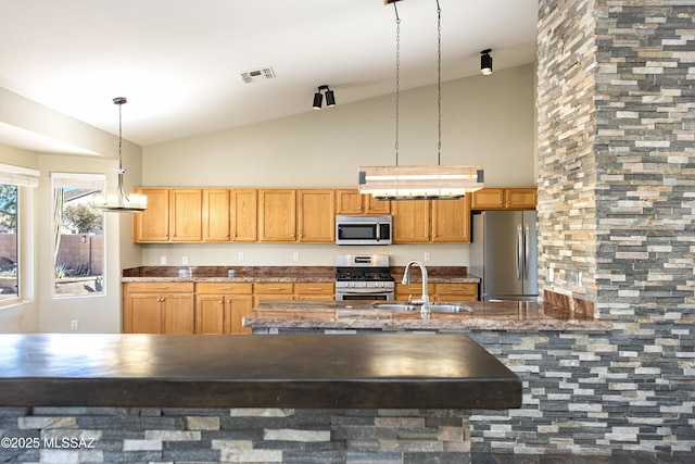 kitchen featuring stainless steel appliances, sink, high vaulted ceiling, and decorative light fixtures