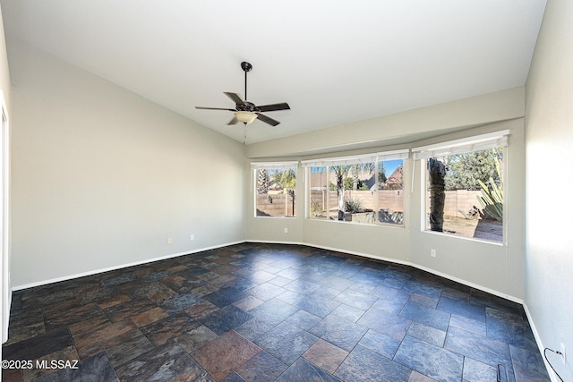 empty room with ceiling fan, lofted ceiling, and a wealth of natural light