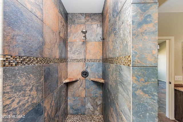 bathroom with a tile shower