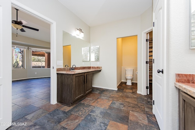 bathroom featuring vanity, ceiling fan, and toilet