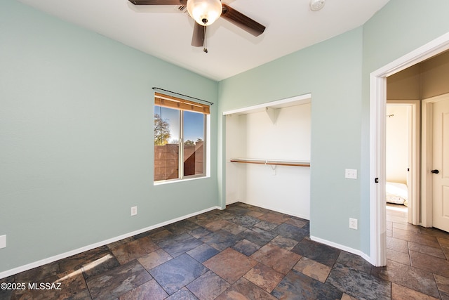 unfurnished bedroom featuring ceiling fan and a closet