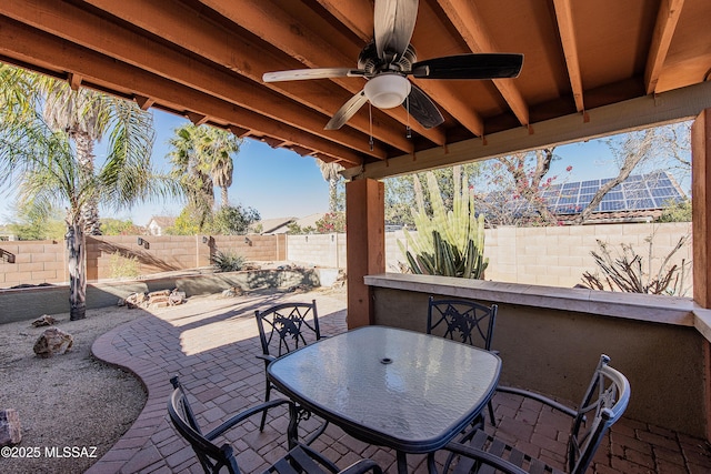 view of patio / terrace featuring a bar and ceiling fan