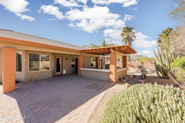 view of patio / terrace featuring exterior kitchen and an outdoor bar