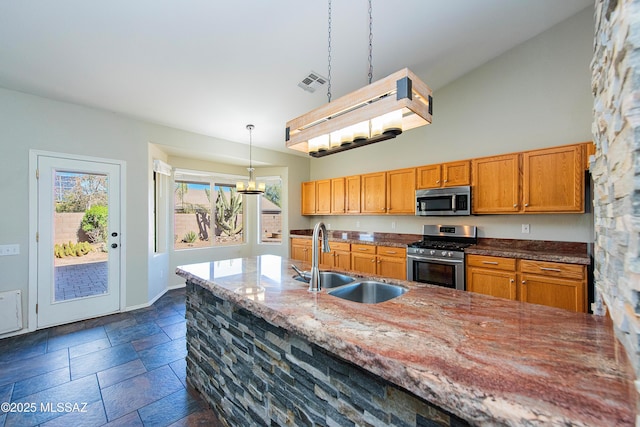 kitchen with pendant lighting, sink, appliances with stainless steel finishes, high vaulted ceiling, and stone countertops