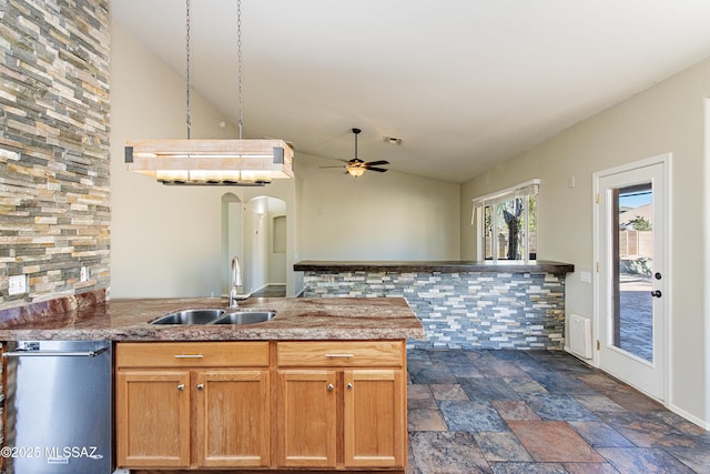 kitchen with lofted ceiling, sink, stainless steel dishwasher, kitchen peninsula, and ceiling fan