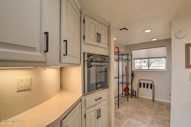 kitchen with oven and white cabinets