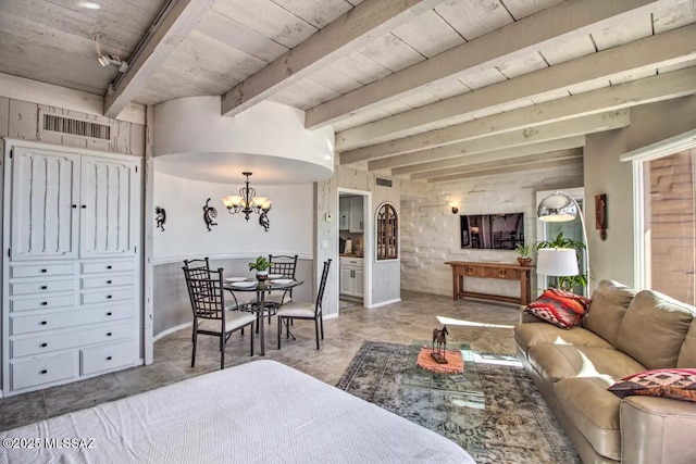 living room featuring beamed ceiling, track lighting, and a chandelier