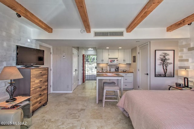 bedroom featuring beamed ceiling