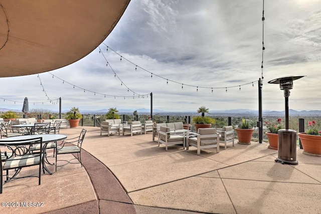 view of patio / terrace with a mountain view and an outdoor hangout area