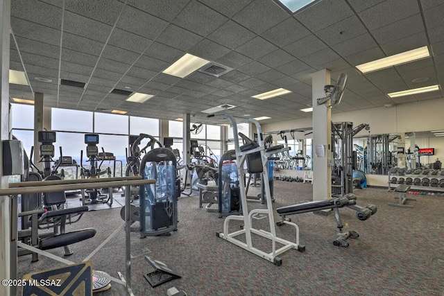 exercise room featuring a drop ceiling