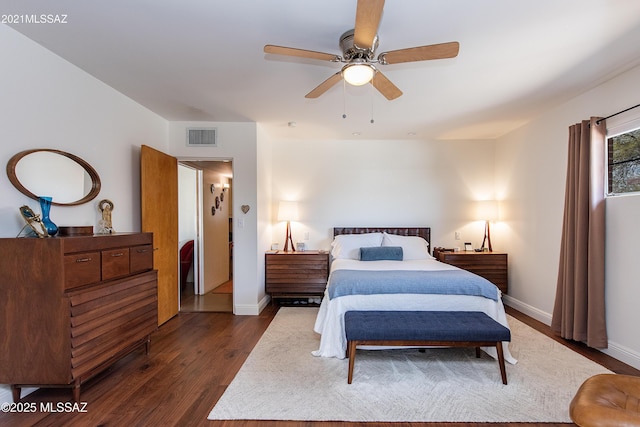 bedroom featuring ceiling fan, visible vents, baseboards, and dark wood-style floors