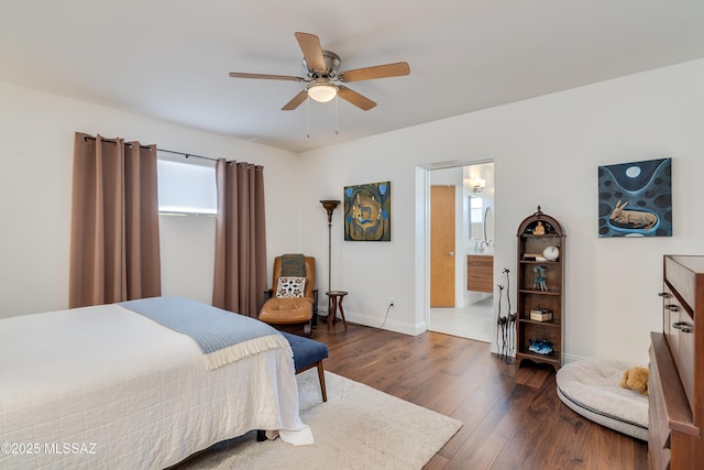 bedroom with dark wood-type flooring, ceiling fan, and ensuite bathroom