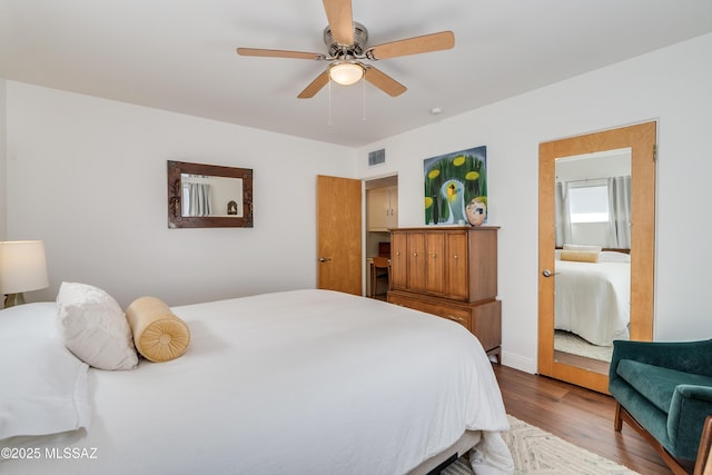 bedroom featuring visible vents, wood finished floors, and a ceiling fan