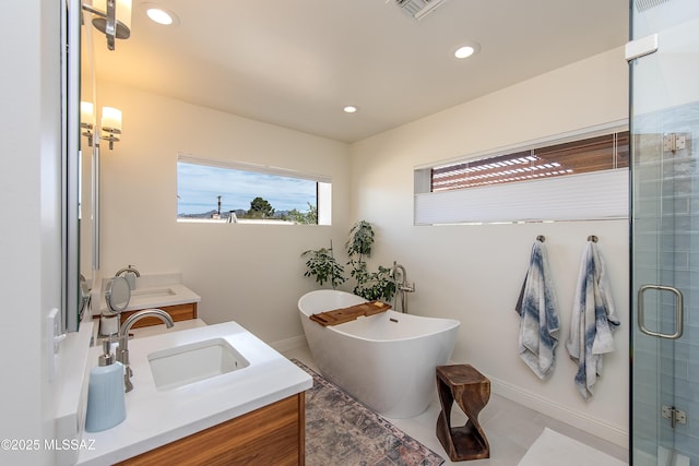 full bathroom featuring vanity, visible vents, a soaking tub, recessed lighting, and a stall shower