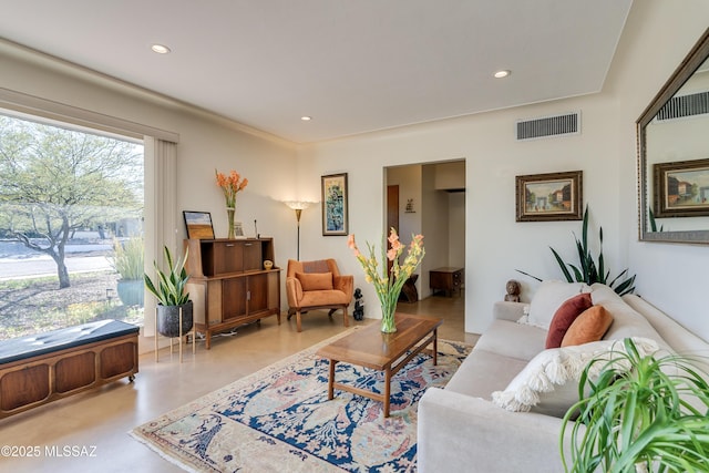 living area featuring recessed lighting, visible vents, and concrete flooring