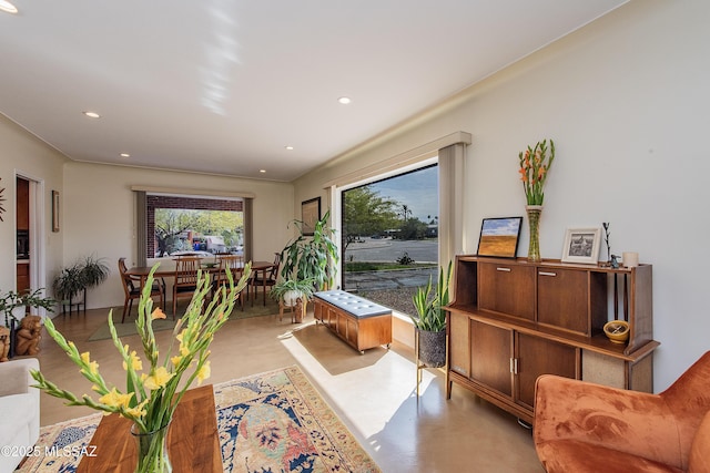 living area featuring recessed lighting and concrete floors