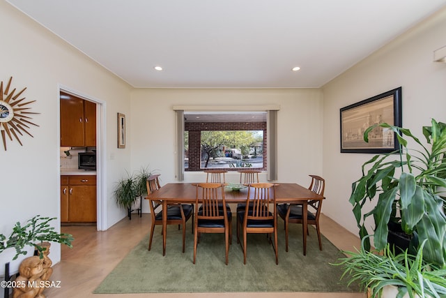 dining area with recessed lighting and concrete floors