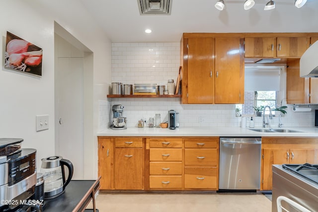 kitchen with a sink, stainless steel appliances, brown cabinets, and visible vents