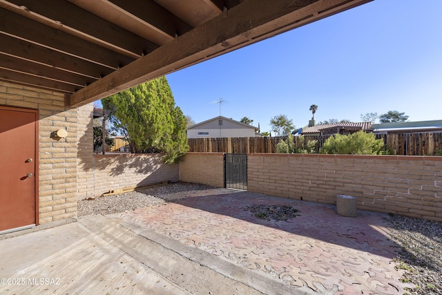 view of patio featuring fence private yard and a gate