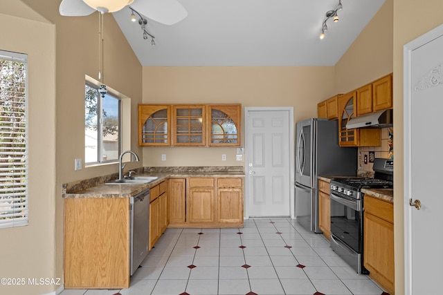 kitchen featuring sink, light tile patterned flooring, vaulted ceiling, and stainless steel appliances