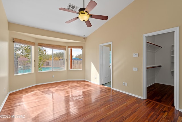 unfurnished room featuring ceiling fan, wood-type flooring, and vaulted ceiling