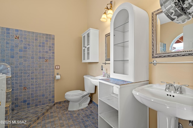 bathroom with sink, toilet, and tile patterned floors