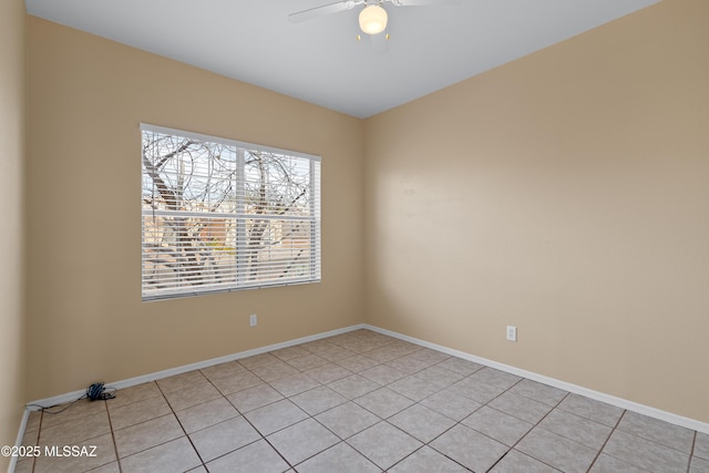 tiled spare room featuring ceiling fan