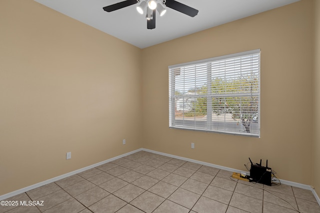 tiled spare room with ceiling fan